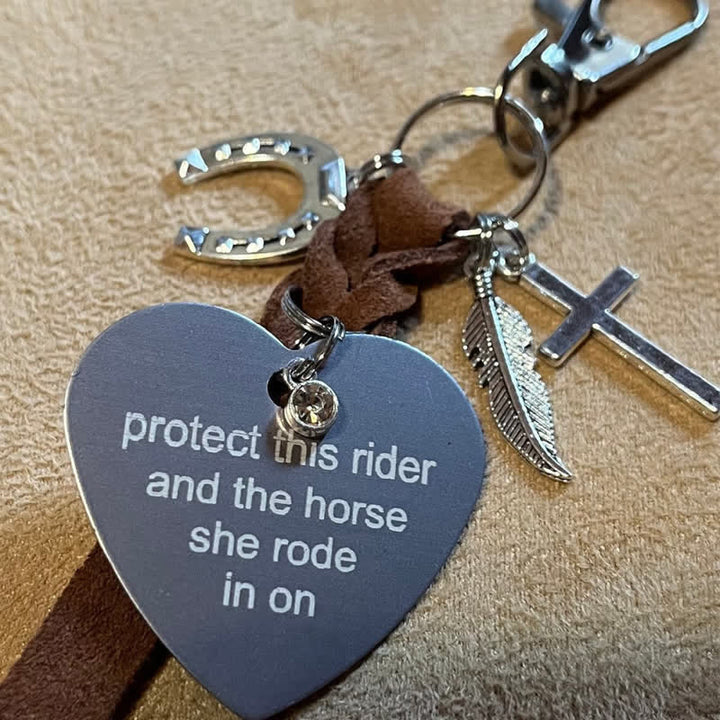 Llavero de cuero con colgante de cruz de herradura de metal en forma de corazón.