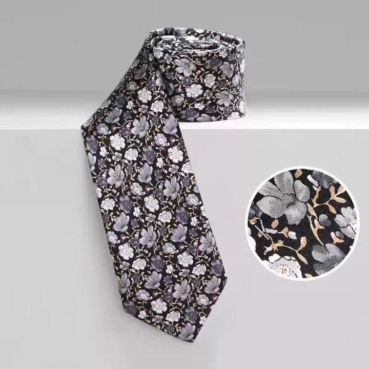 Corbata de seda pura con estampado floral pequeño en gris y negro para hombre