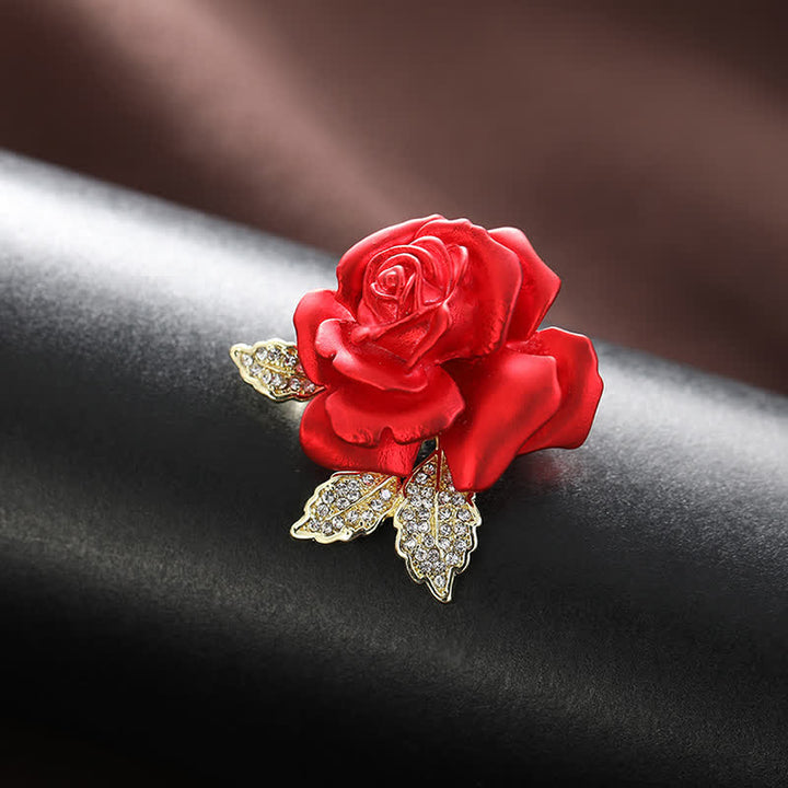Broche de flor con diamantes de imitación y rosa roja y azul