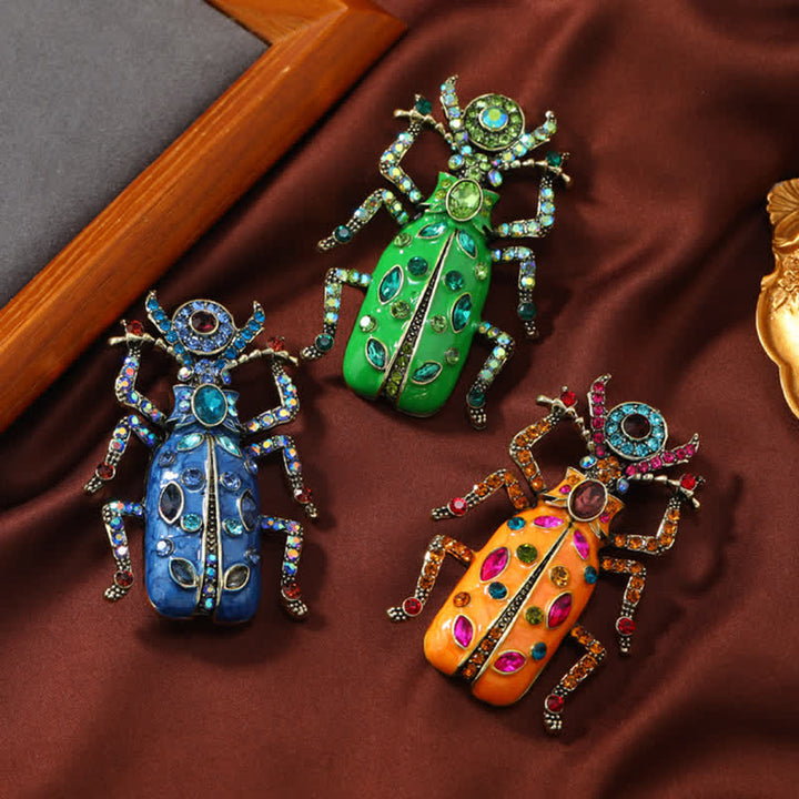 Broche antiguo de cristal coloreado con forma de escarabajo esmaltado de gran tamaño