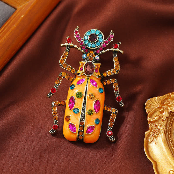 Broche antiguo de cristal coloreado con forma de escarabajo esmaltado de gran tamaño