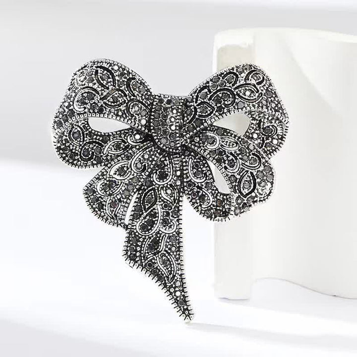 Broche de plata antigua con forma de lazo y diamantes de imitación para mujer