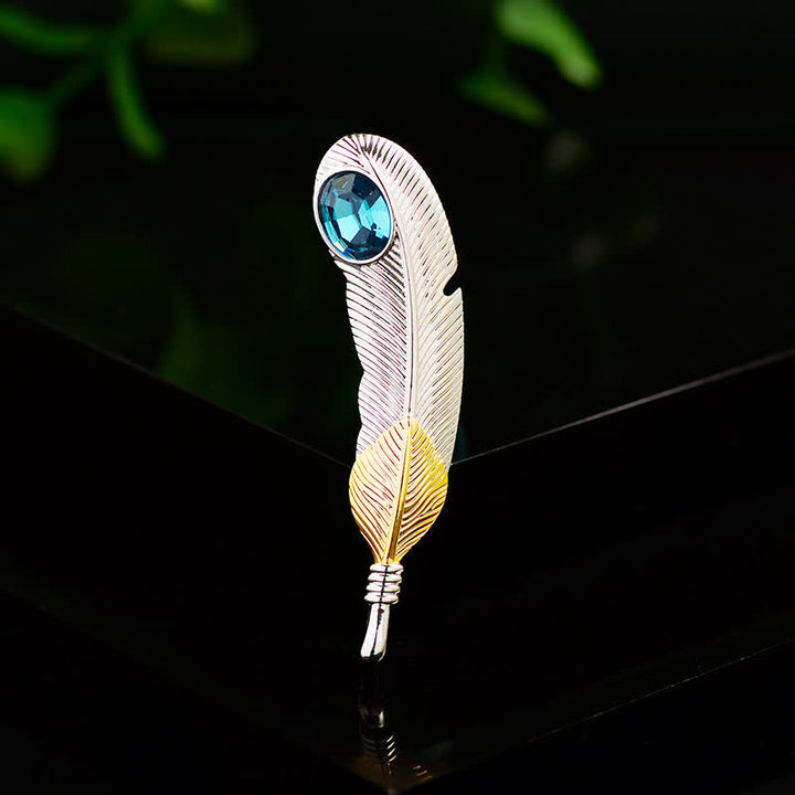 Broche unisex con forma de pluma de cristal azul sintético