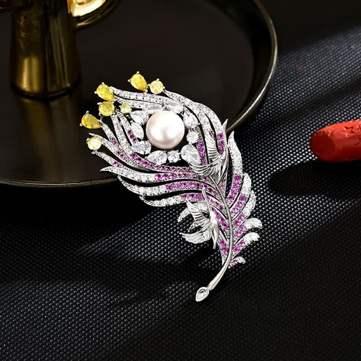 Broche unisex con forma de pluma de perla y diamantes de imitación rosas y amarillos