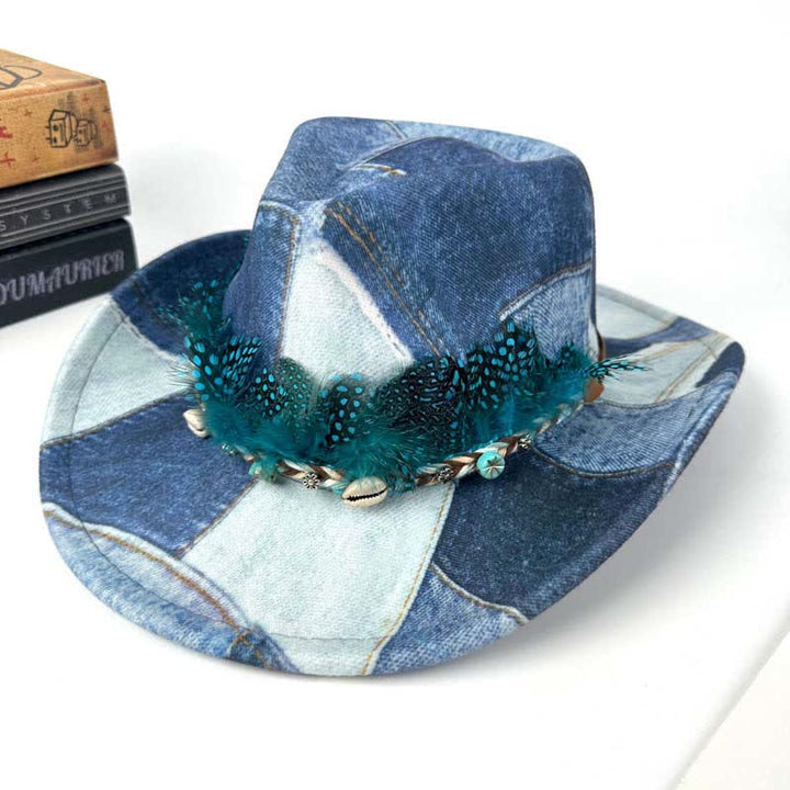 Sombrero vaquero de mezclilla con diseño de bloques de color y plumas verdes.
