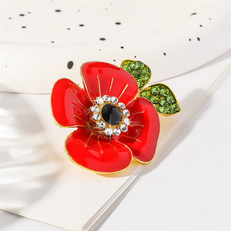 Broche de amapola roja vibrante con pétalos brillantes y hojas adornadas con cristales brillantes y borde dorado. - image 1