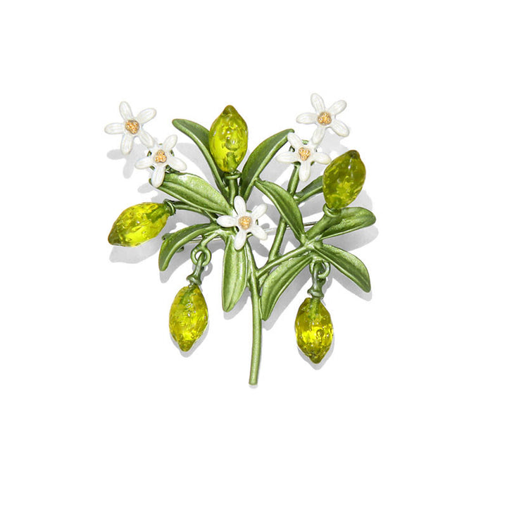 Broche de mujer con forma de gota de limón y planta verde.