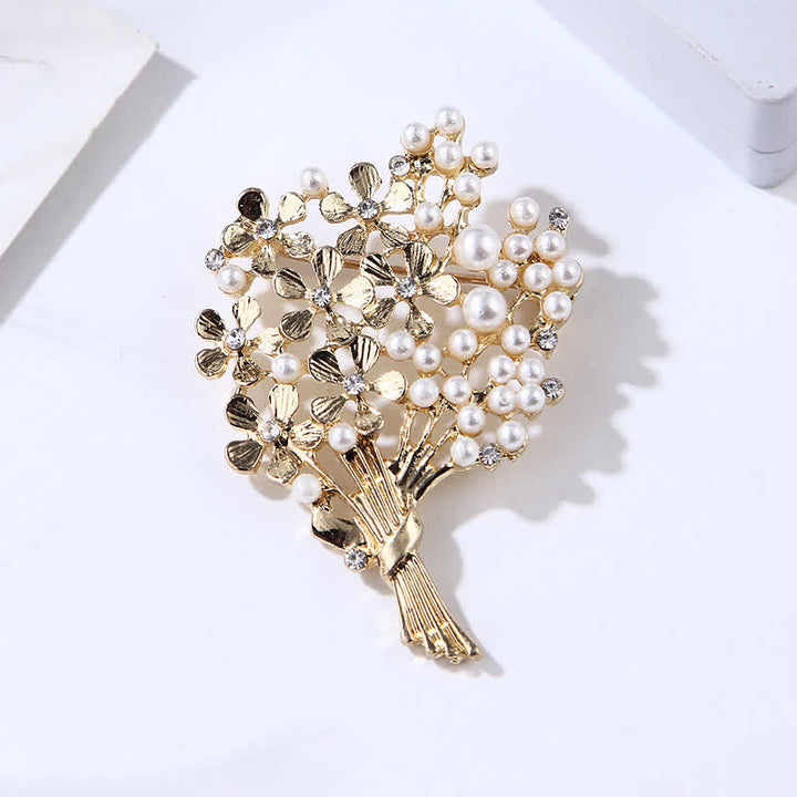 Broche de mujer con ramo de perlas y flores doradas