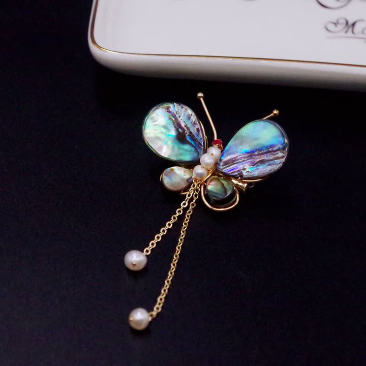Broche de borla con forma de mariposa y concha para mujer